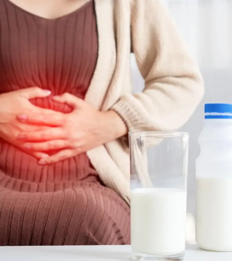 an image of a woman with stomach cramps from drinking milk