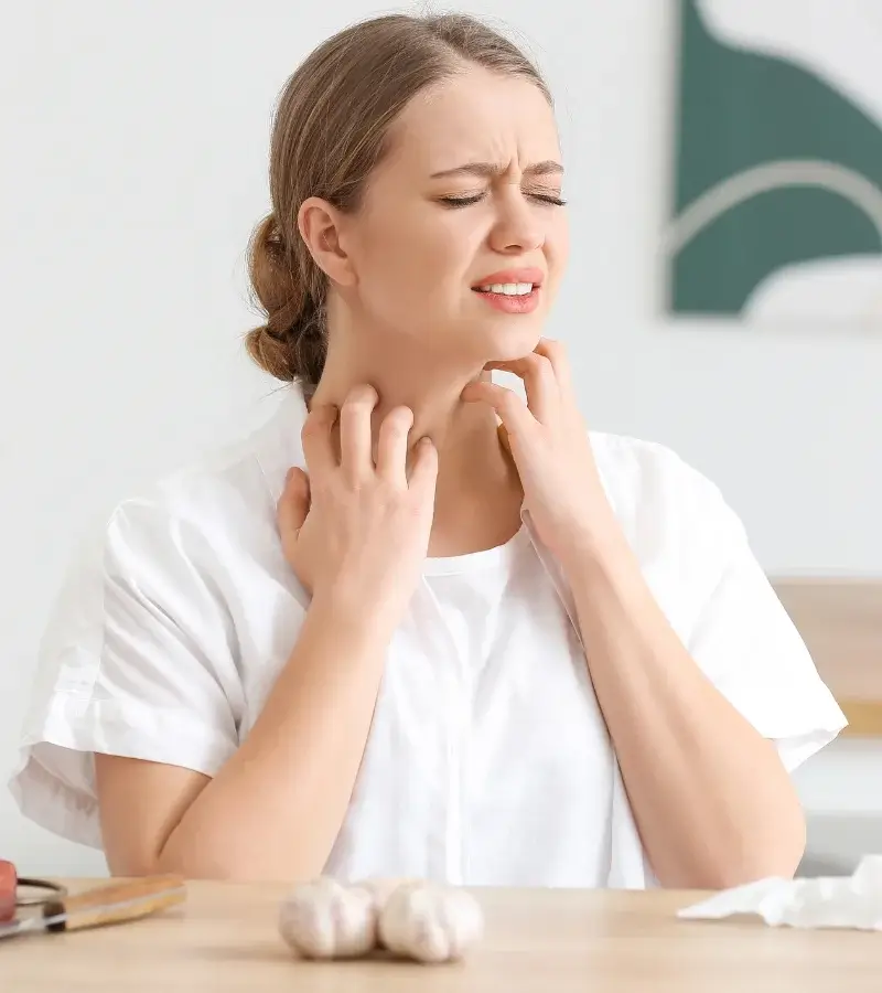 an image of a woman itching her neck